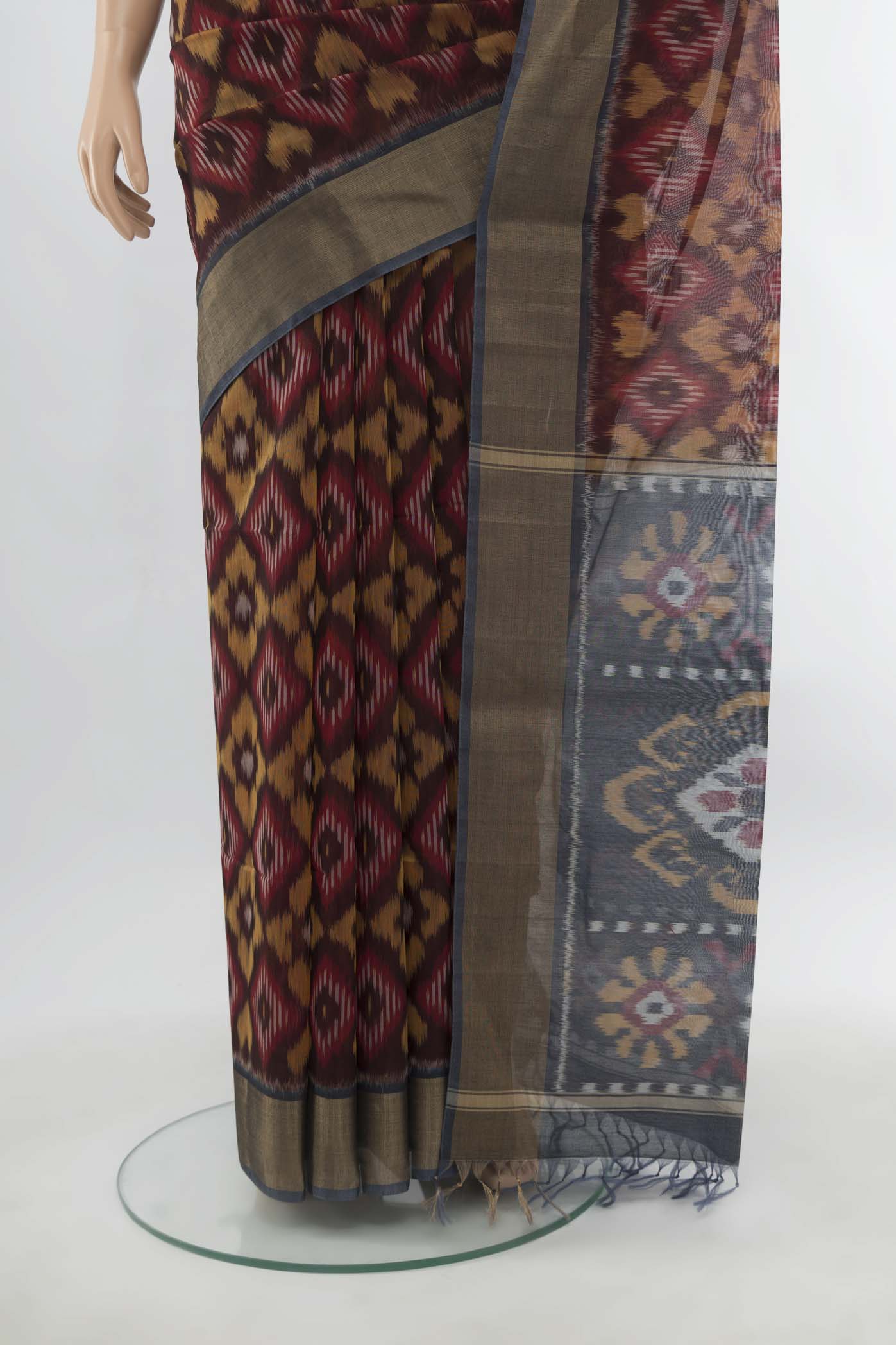 Pleats and pallu of Maroon Maheshwari Silk Cotton Saree with Ikat Print on the body and Silk Border. 
