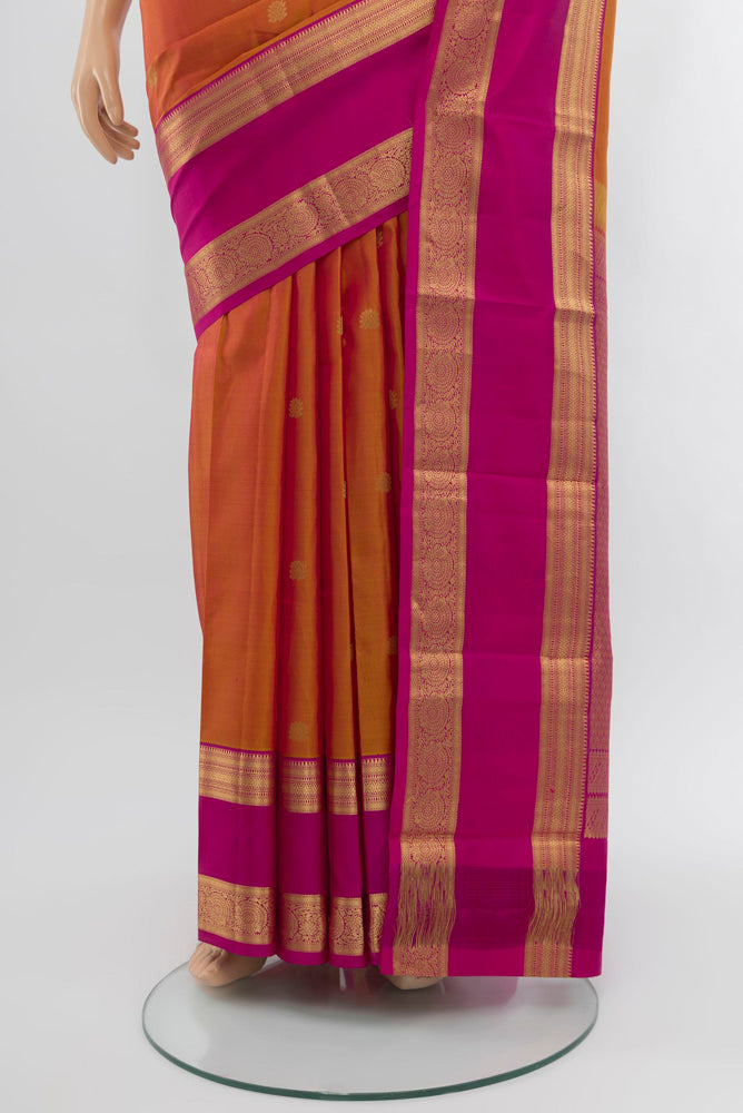 Pleats and pallu of Peach Kanchipuram Silk Saree with Zari Butta on the body and Silk Border. 