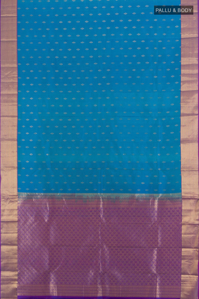 Flat view of Peacock Blue Kanchipuram Silk Saree with Zari Butta on the body and Silk Border. 