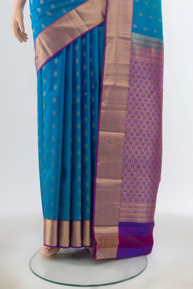 Pleats and pallu of Peacock Blue Kanchipuram Silk Saree with Zari Butta on the body and Silk Border. 