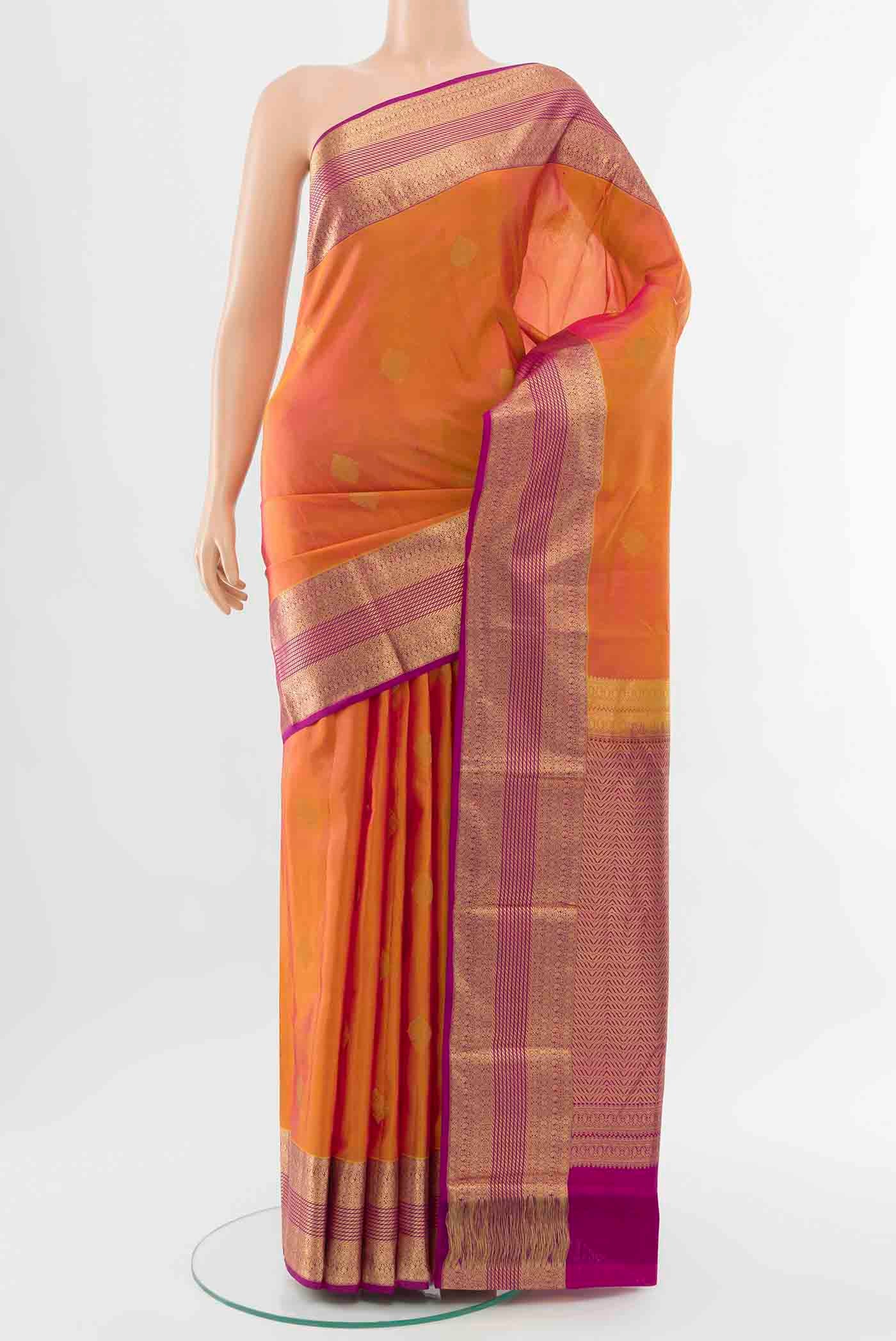 Yellow with Pink Color Kanchipuram Silk Saree with Zari Butta on the body and Zari Border displayed on a mannequin