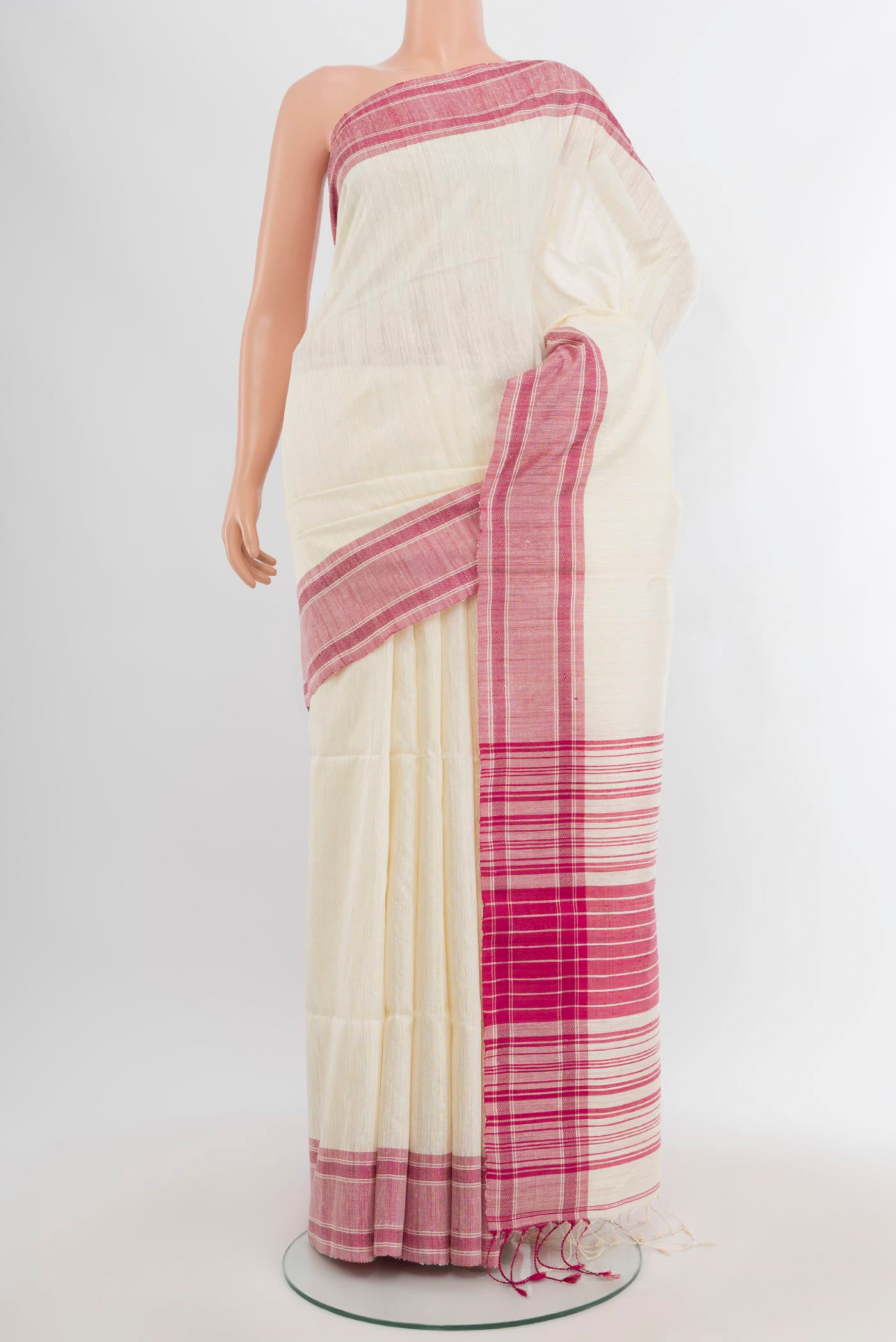 Cream Tussar Silk Saree with Plain Body and Plain Border.  displayed on a mannequin
