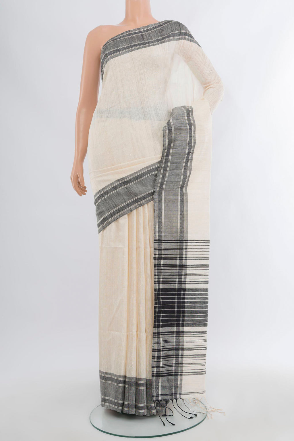 Off White Tussar Silk Saree with Plain Body and Plain Border.  displayed on a mannequin