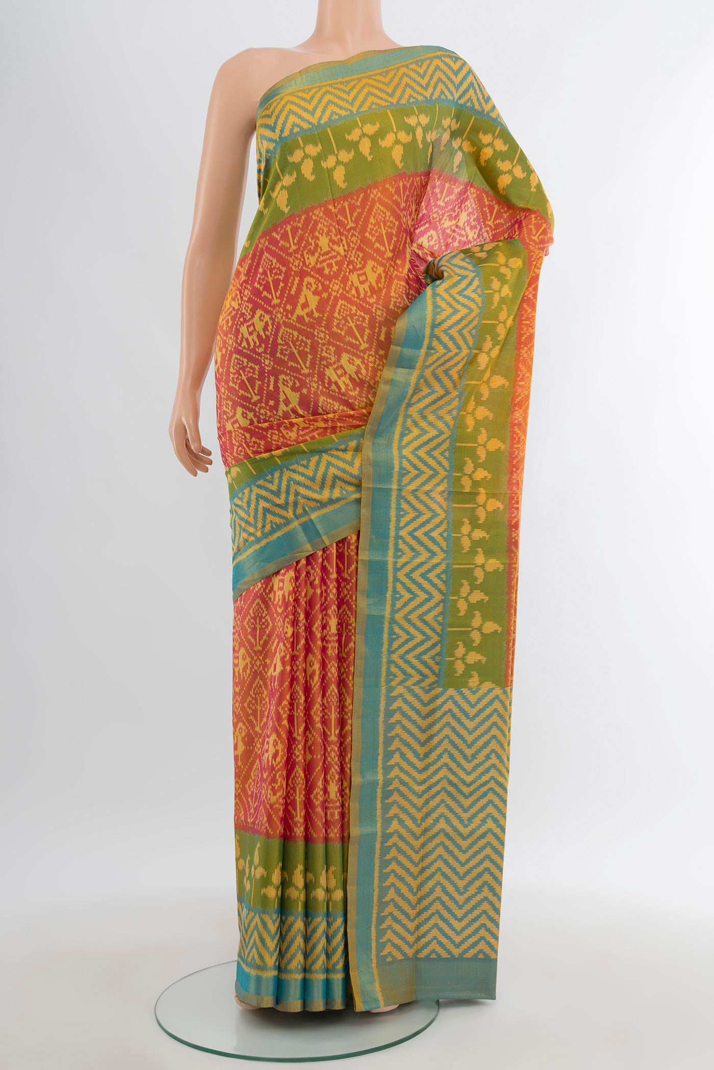 Orange Rajkot Patola Silk Saree with Pure Ikat on the body and Ikat Border.  displayed on a mannequin