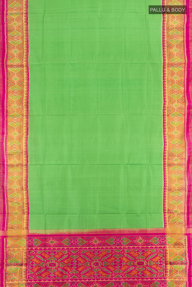 Flat view of Parrot Green Rajkot Patola Silk Saree with Batik Print on the body and Silk Border. 