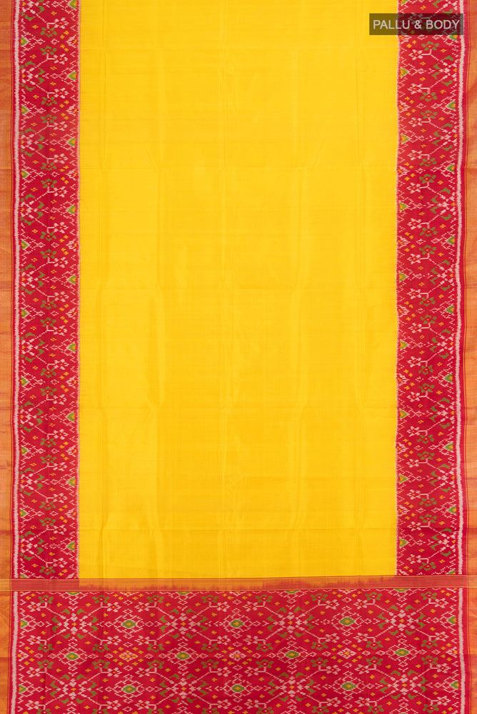 Flat view of Yellow Rajkot Patola Silk Saree with Ikat Print on the body and Silk Border. 