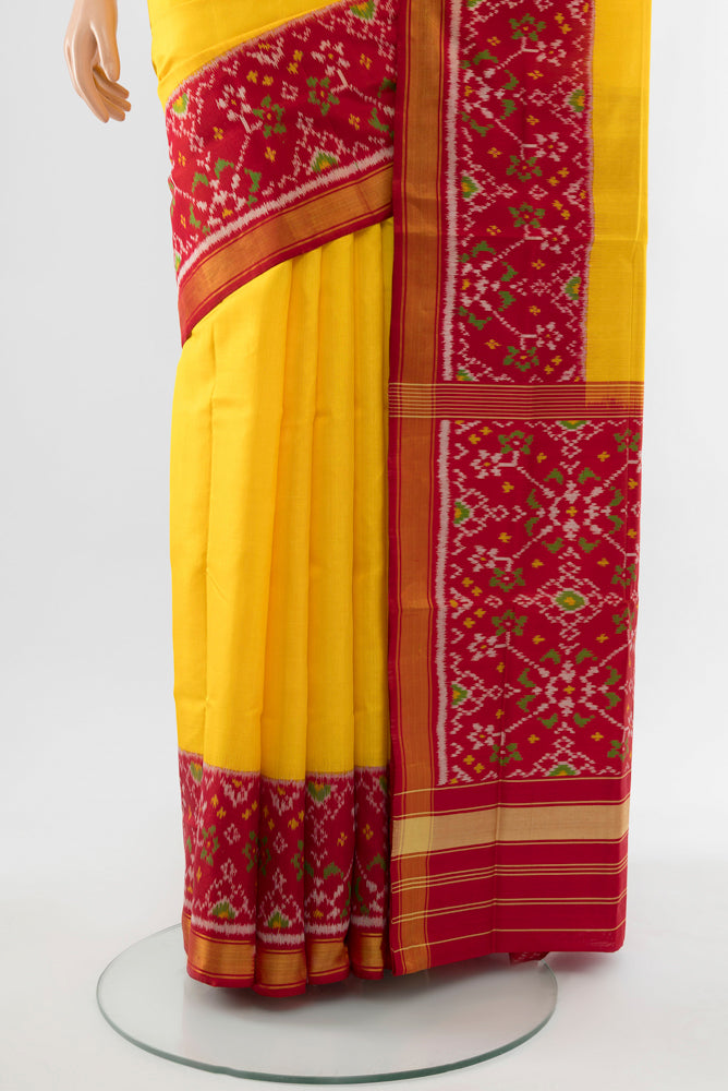 Pleats and pallu of Yellow Rajkot Patola Silk Saree with Ikat Print on the body and Silk Border. 
