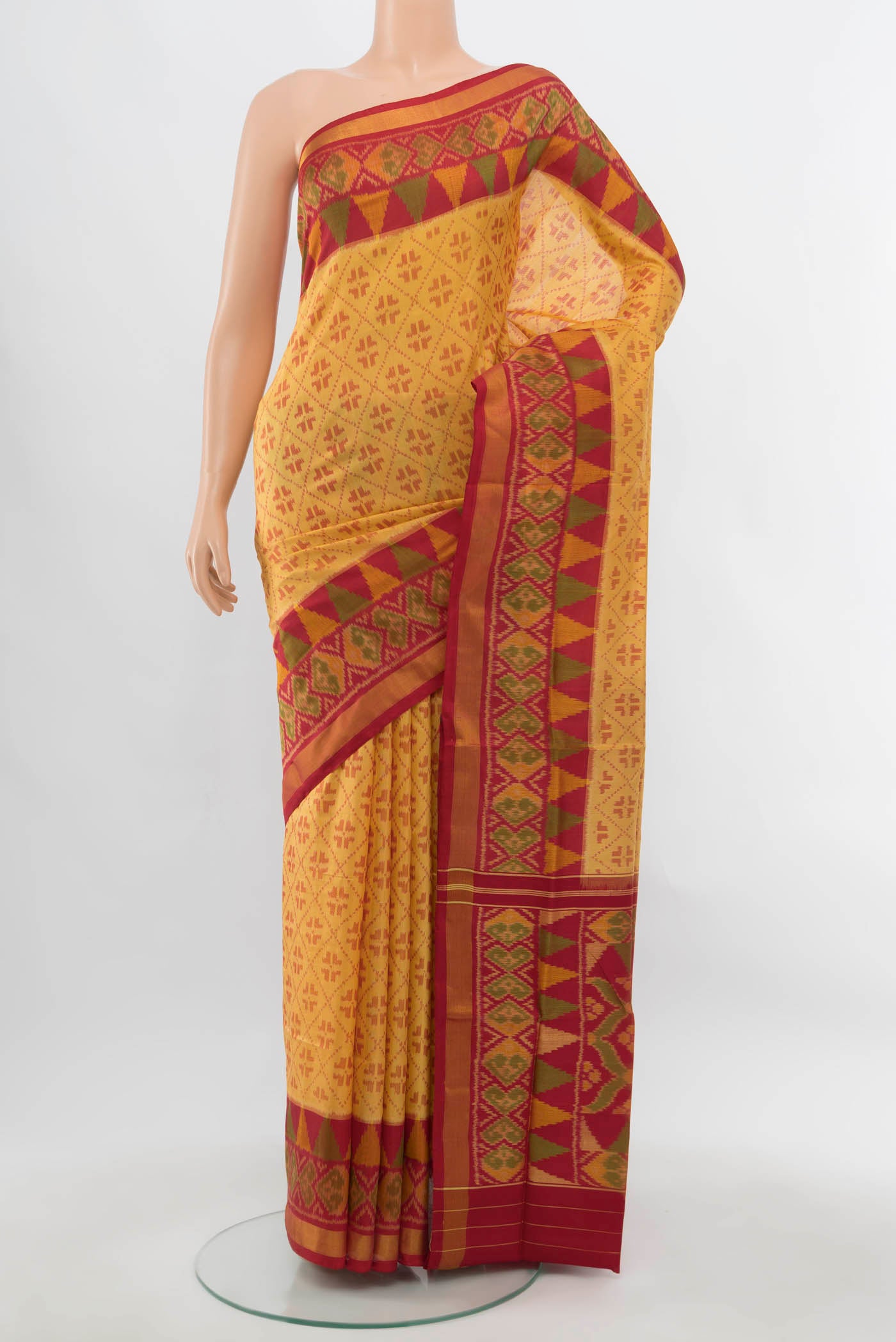 Beige Rajkot Patola Silk Saree with Ikat Print on the body and Silk Border.  displayed on a mannequin