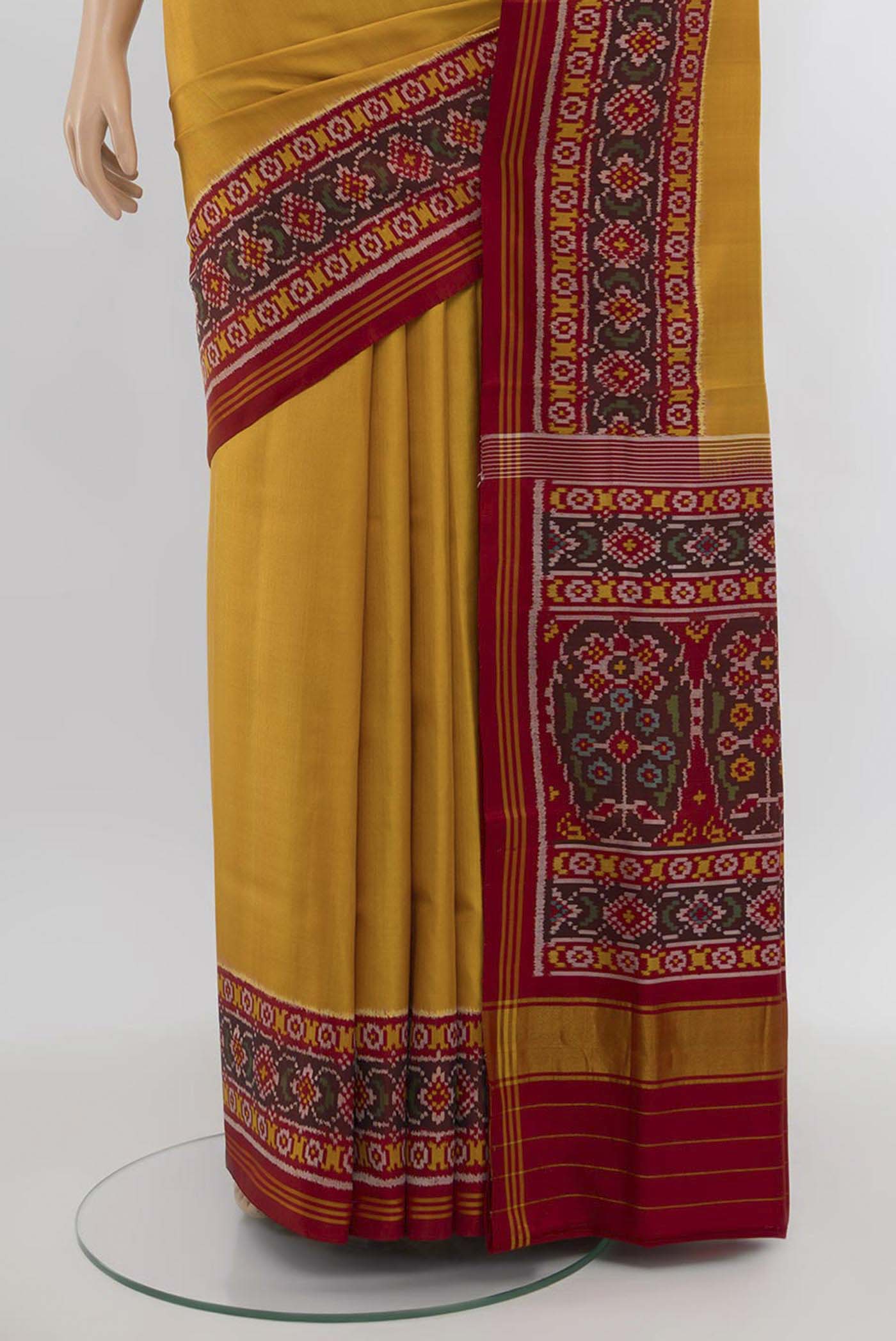 Pleats and pallu of Yellow Rajkot Patola Silk Saree with Ikat Print on the body and Silk Border. 