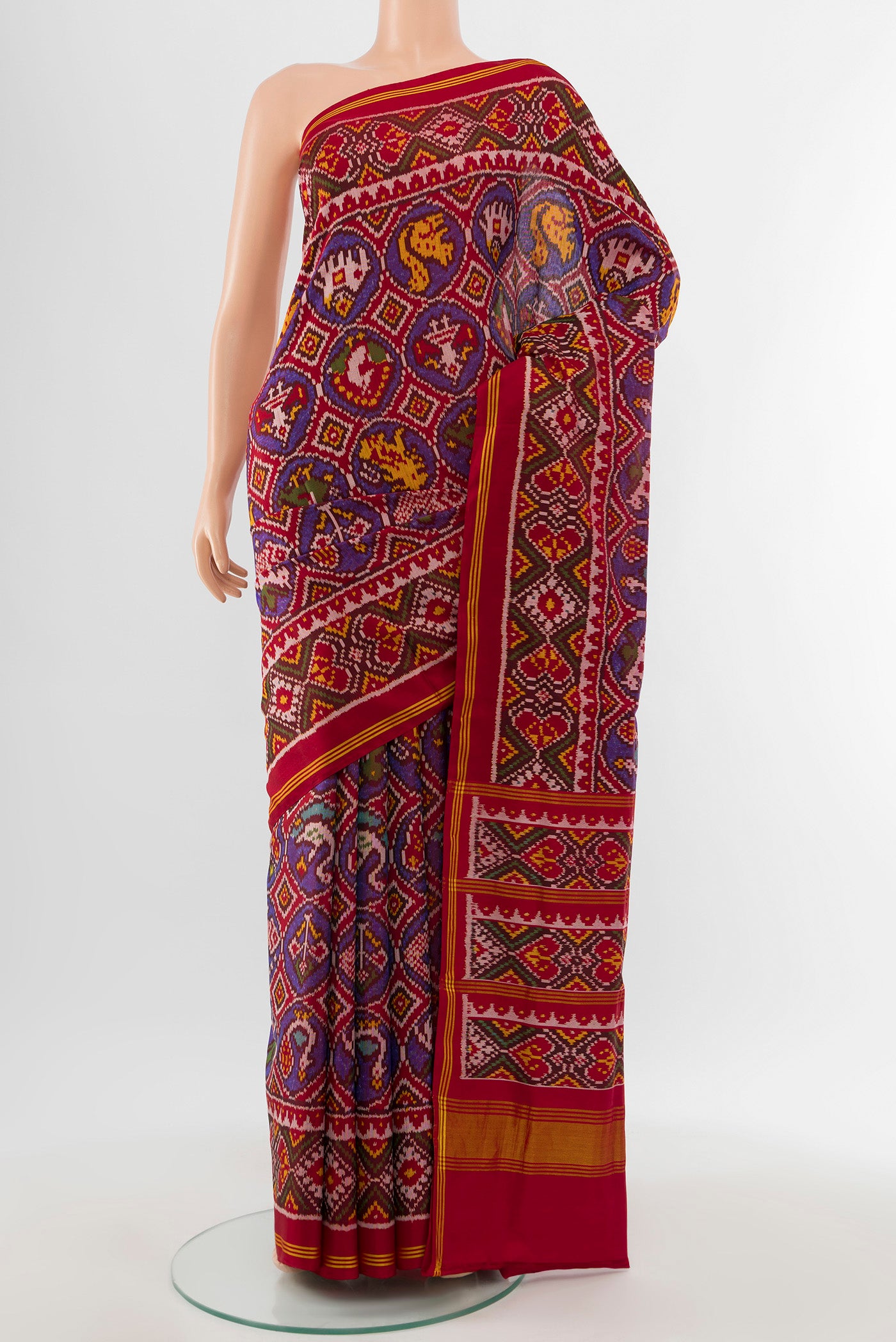 Multi Color Rajkot Patola Silk Saree with Ikat Print on the body and Silk Border.  displayed on a mannequin