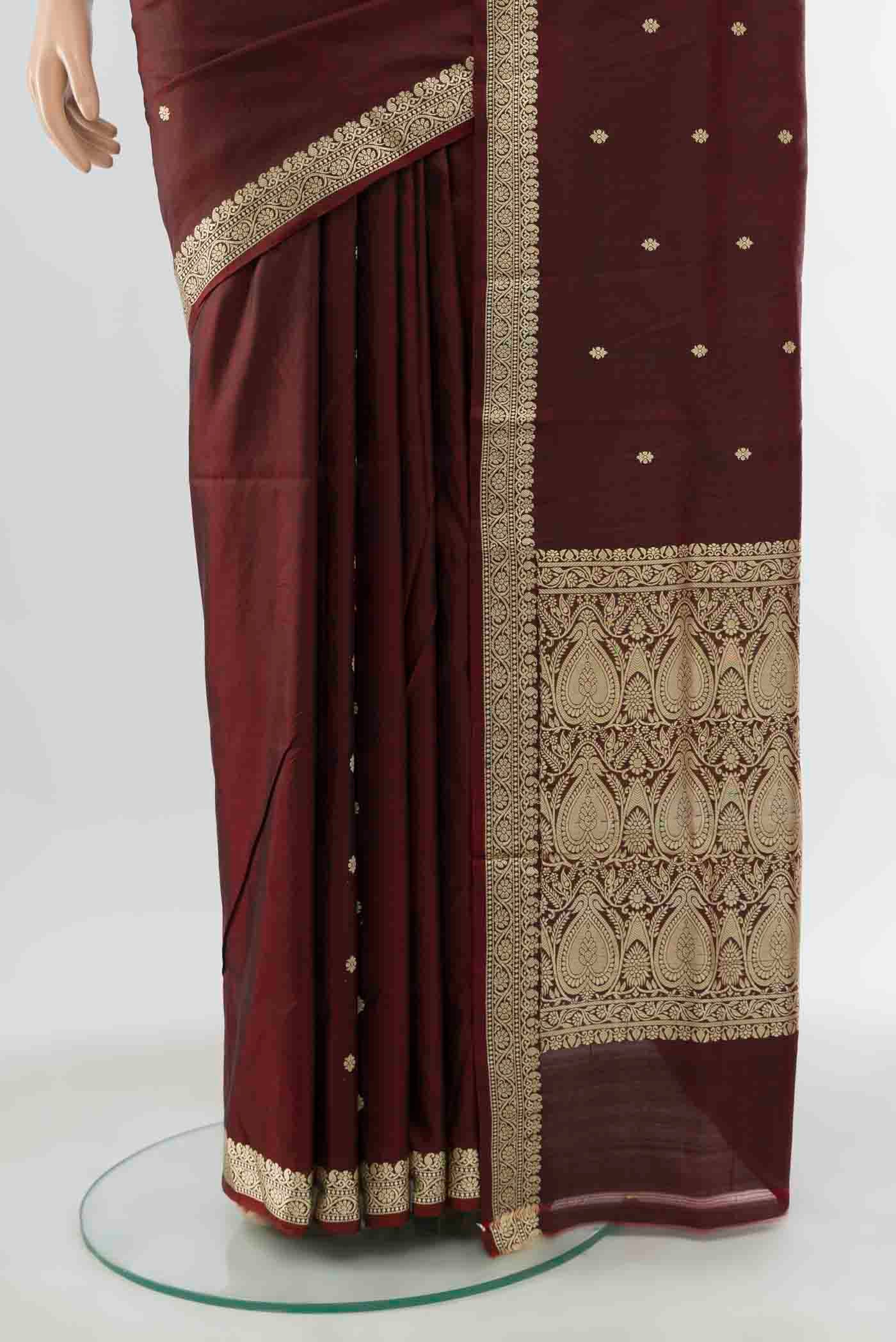 Pleats and pallu of Maroon Banarasi Katan Silk Saree with Zari Butta on the body and Silk Border