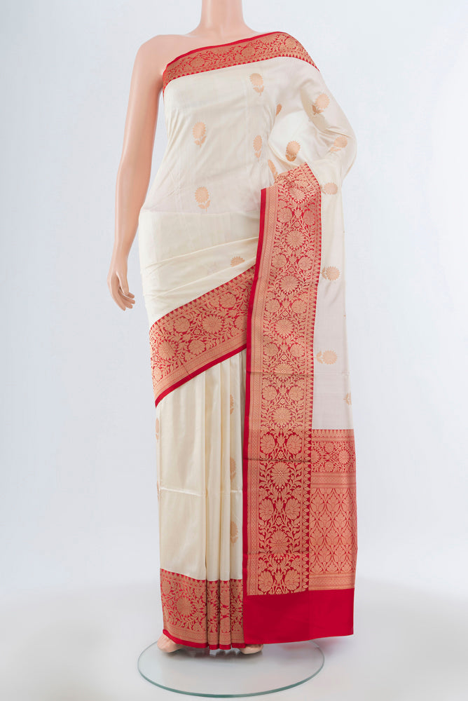 Cream Banarasi Katan Silk Saree with Zari Butta on the body and Silk Border.  displayed on a mannequin