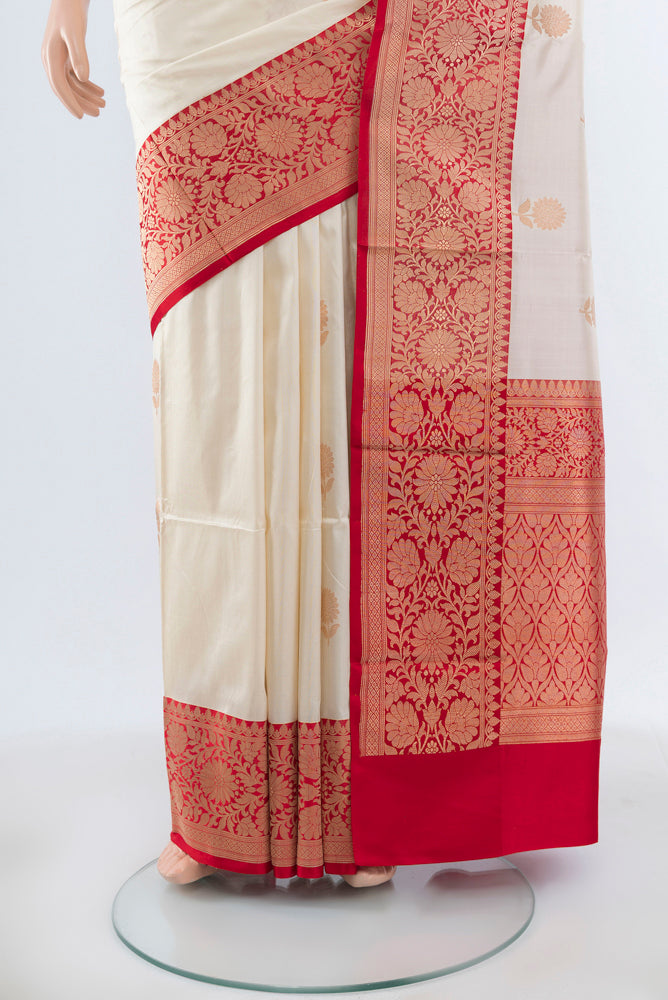 Pleats and pallu of Cream Banarasi Katan Silk Saree with Zari Butta on the body and Silk Border. 