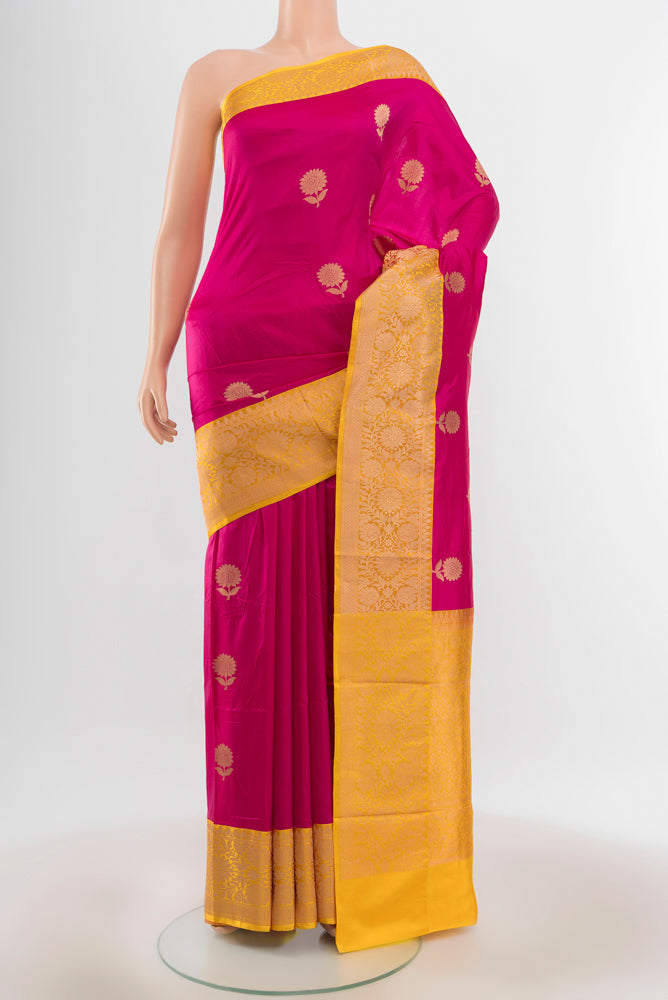 Pure Silk Pure Zari Magenta Banarasi Katan Saree with Zari Butta on the body and Silk Border.  displayed on a mannequin