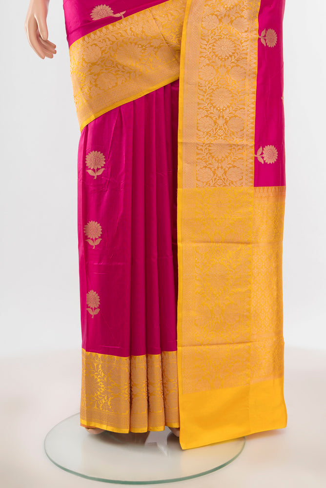 Pleats and pallu of Pure Silk Pure Zari Magenta Banarasi Katan Saree with Zari Butta on the body and Silk Border. 
