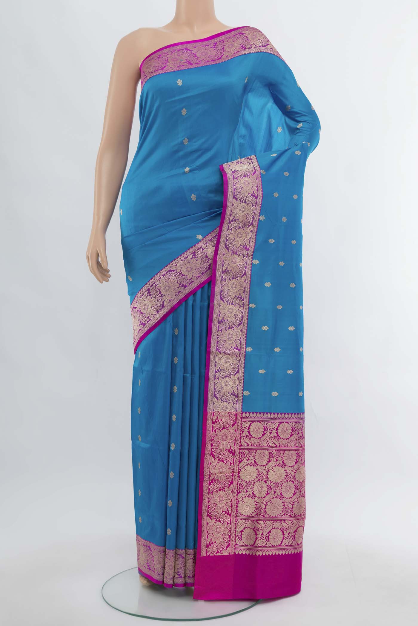 Light Blue Banarasi Katan Silk Saree with Zari Butta on the body and Silk Border.  displayed on a mannequin