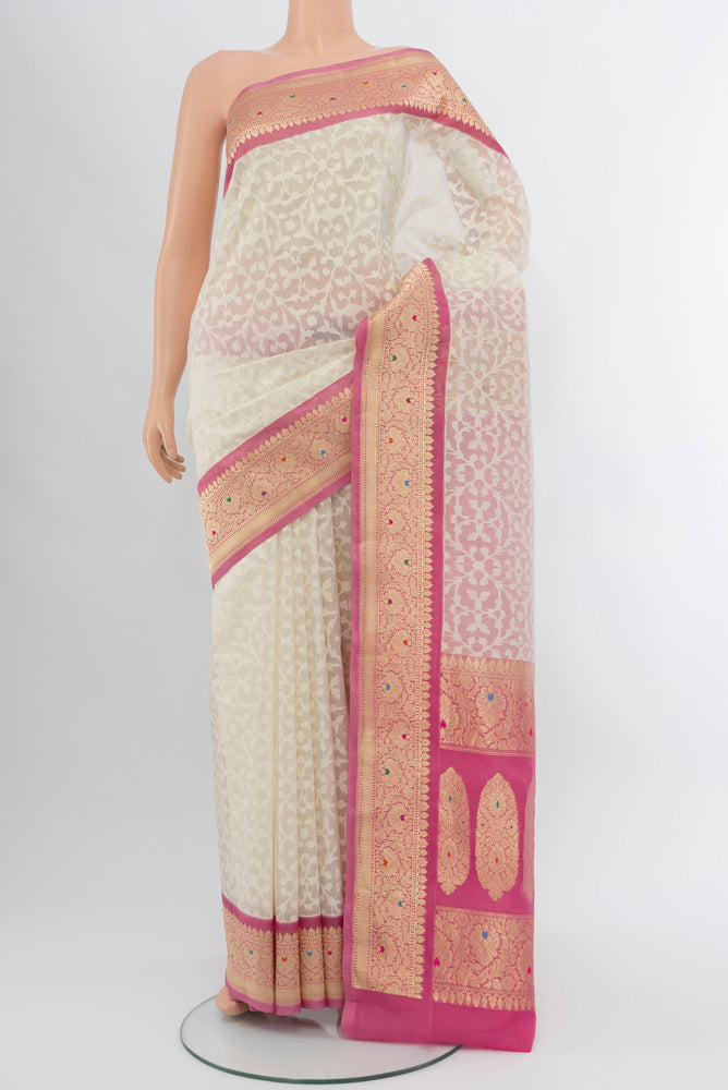 Cream Banarasi Kota Silk Saree with Zari Butta on the body and Silk Border.  displayed on a mannequin