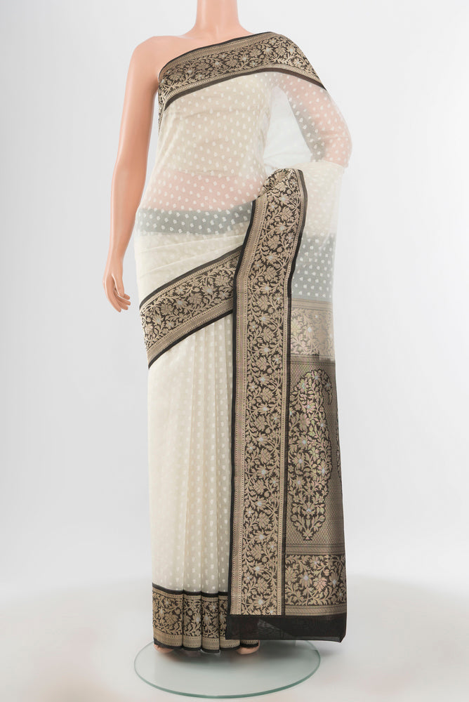 Pure Silk Pure Zari Off White Banarasi Saree with Zari Butta on the body and Silk Border.  displayed on a mannequin