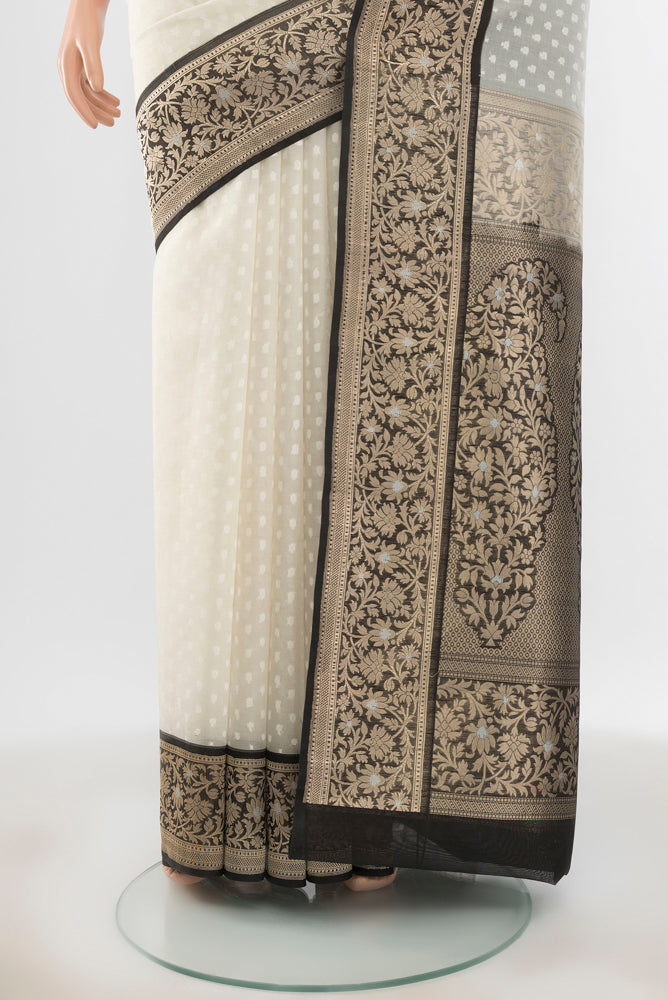 Pleats and pallu of Pure Silk Pure Zari Off White Banarasi Saree with Zari Butta on the body and Silk Border. 