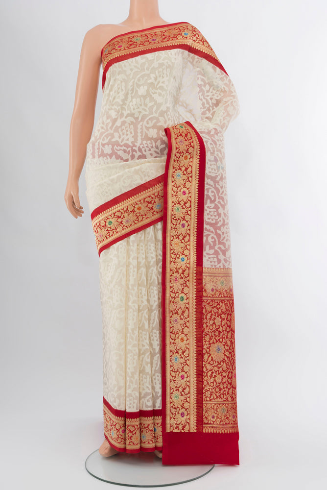 Cream Banarasi Kora Silk Saree with Zari Butta on the body and Silk Border.  displayed on a mannequin