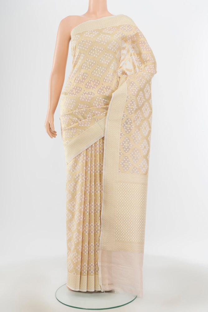 Pure Silk Pure Zari Cream Banarasi Saree with Zari Butta on the body and Silk Border.  displayed on a mannequin