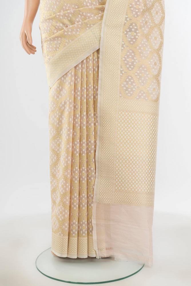 Pleats and pallu of Pure Silk Pure Zari Cream Banarasi Saree with Zari Butta on the body and Silk Border. 