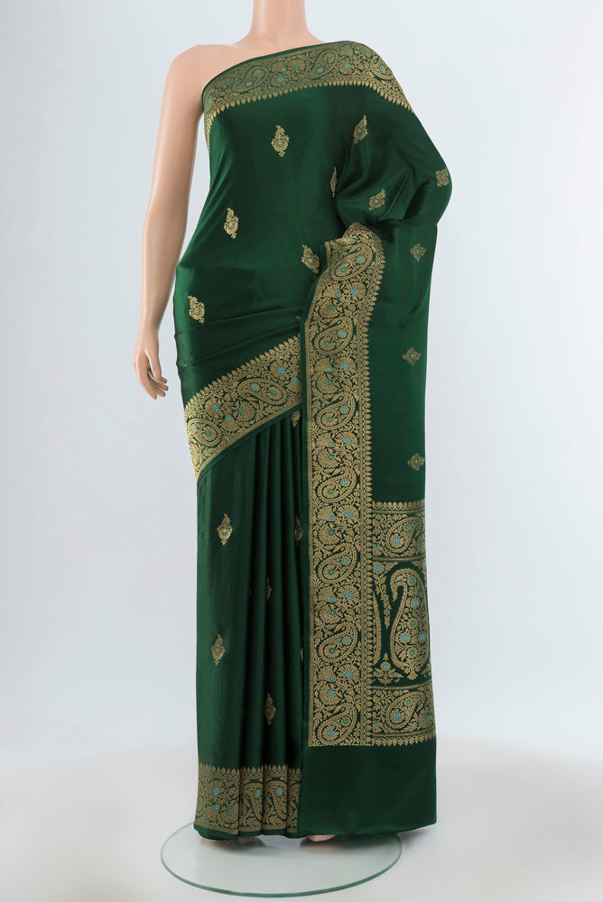 Pure Silk Pure Zari Bottle Green Banarasi Katan Saree with Zari Butta on the body and Silk Border.  displayed on a mannequin