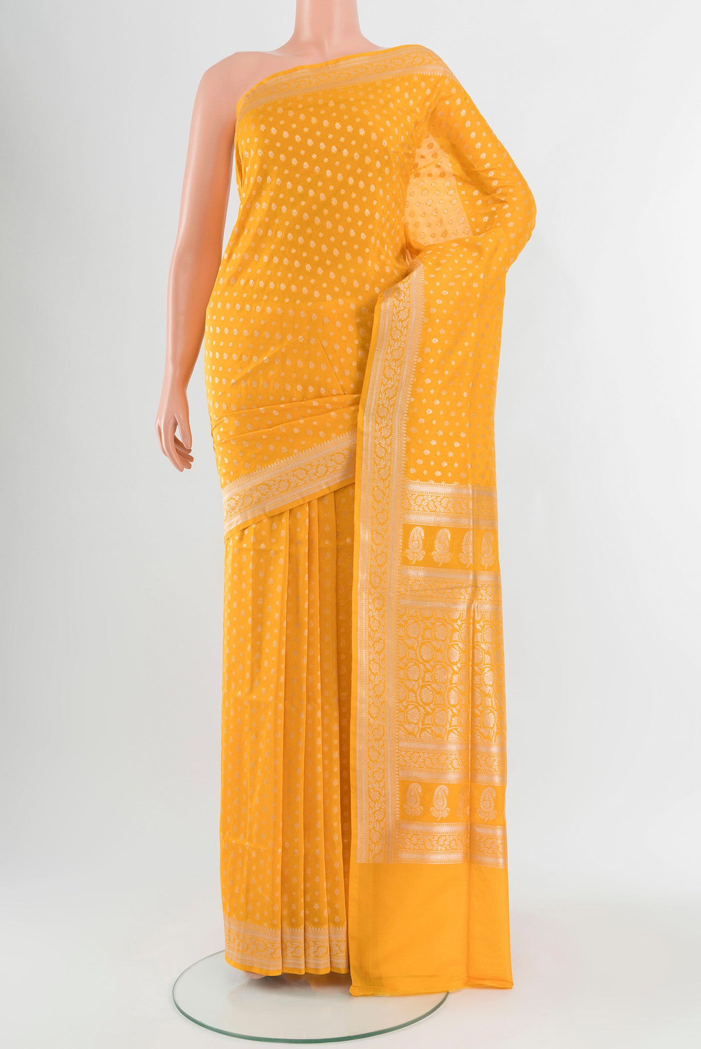 Yellow Banarasi Silk Saree with Zari Butta on the body and Zari Border.  displayed on a mannequin