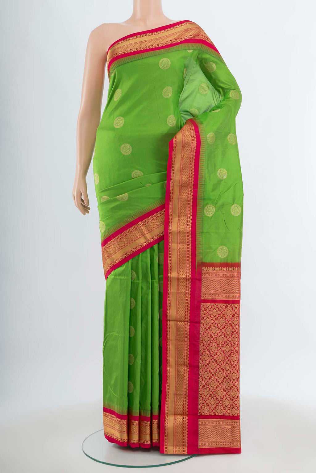 Parrot Green Bangalore Silk Saree with Zari Butta on the body and Silk Border.  displayed on a mannequin