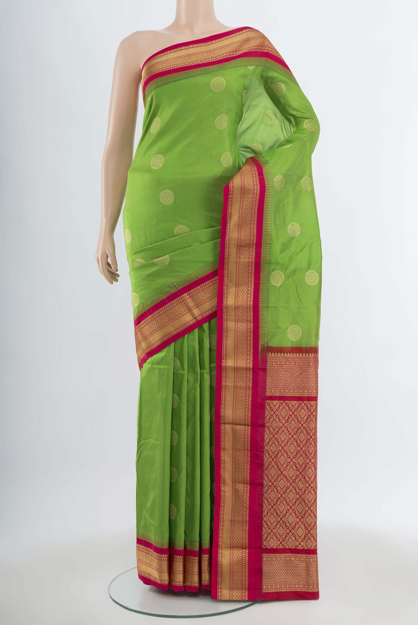 Parrot Green Bangalore Silk Saree with Zari Butta on the body and Silk Border.  displayed on a mannequin