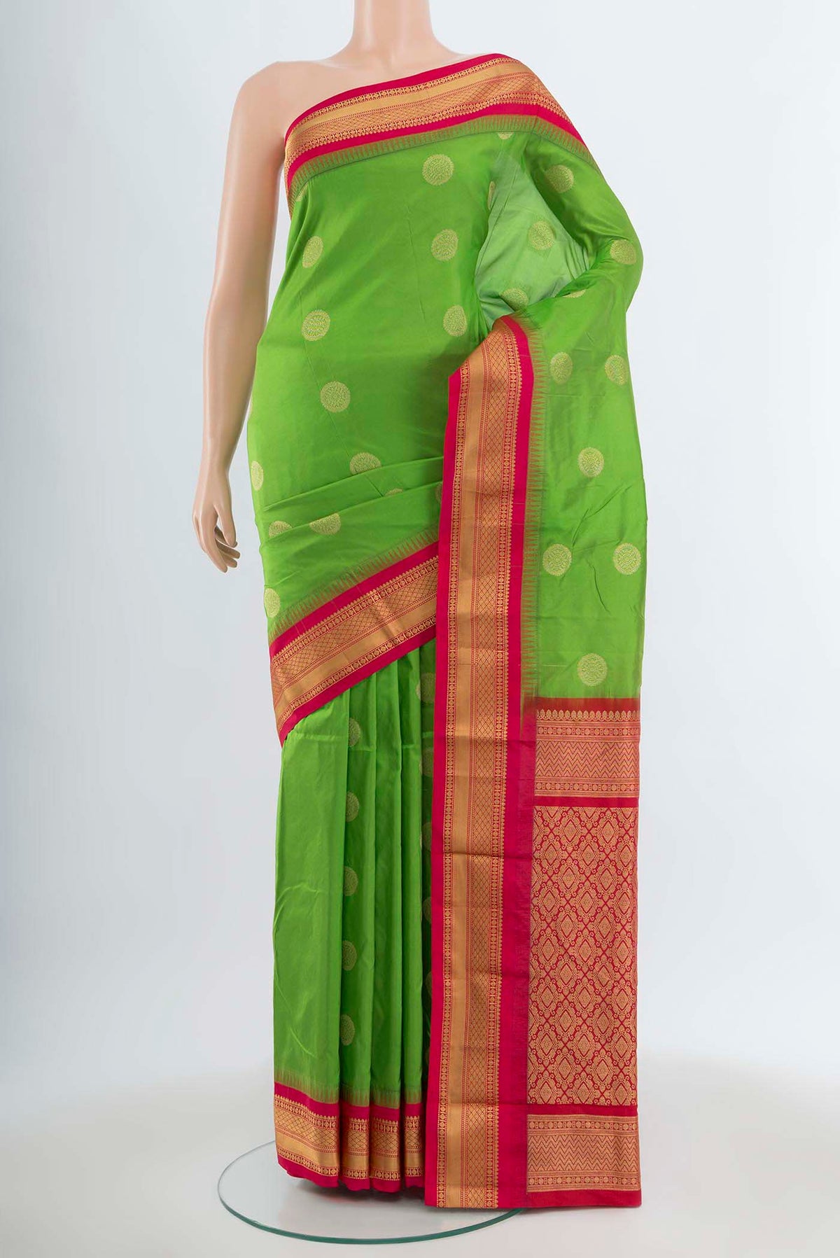 Parrot Green Bangalore Silk Saree with Zari Butta on the body and Silk Border.  displayed on a mannequin