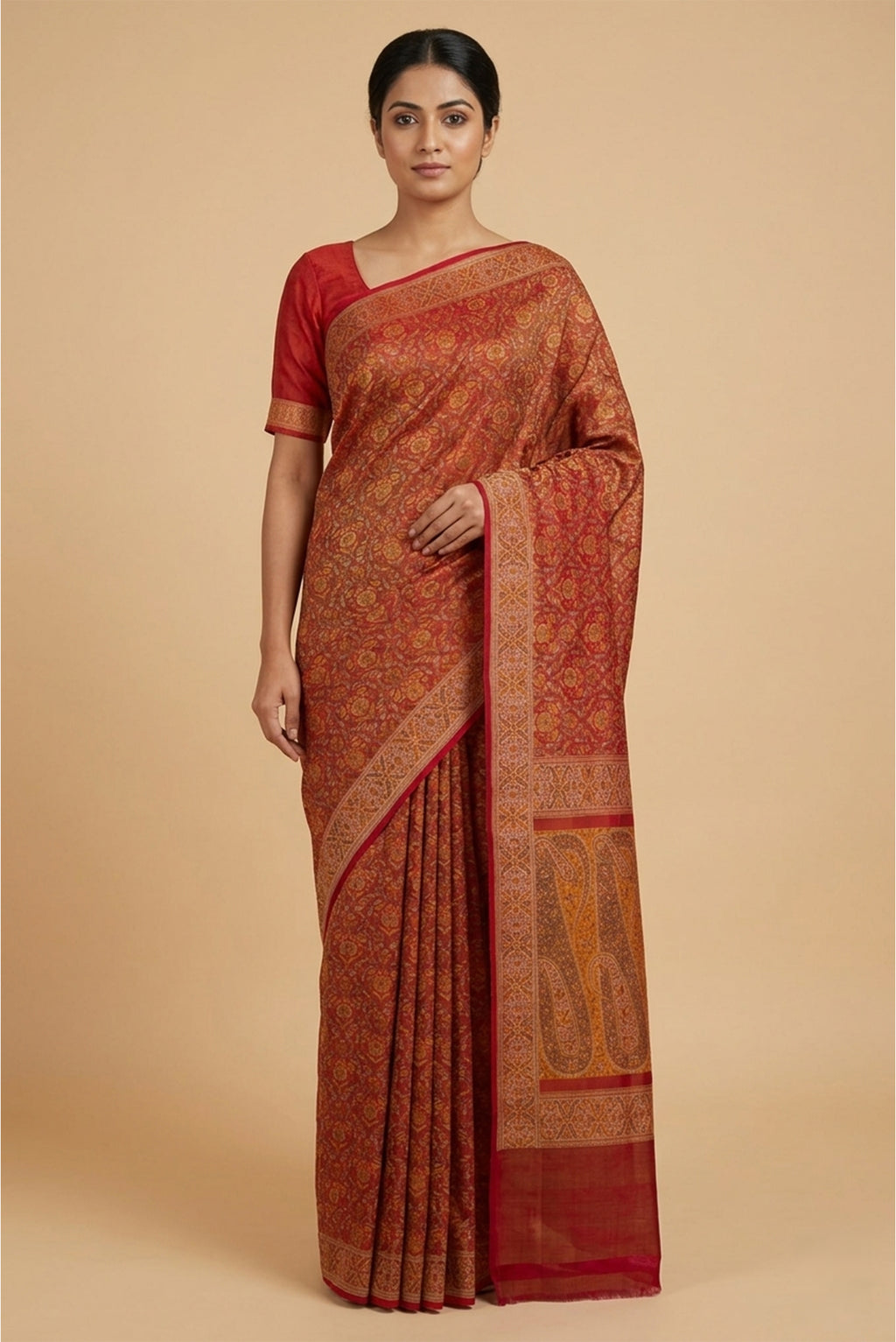 Model wearing a Deep Red Banarasi Tanchoi Silk Saree with Jacquard design on the body and Temple Thread Border.