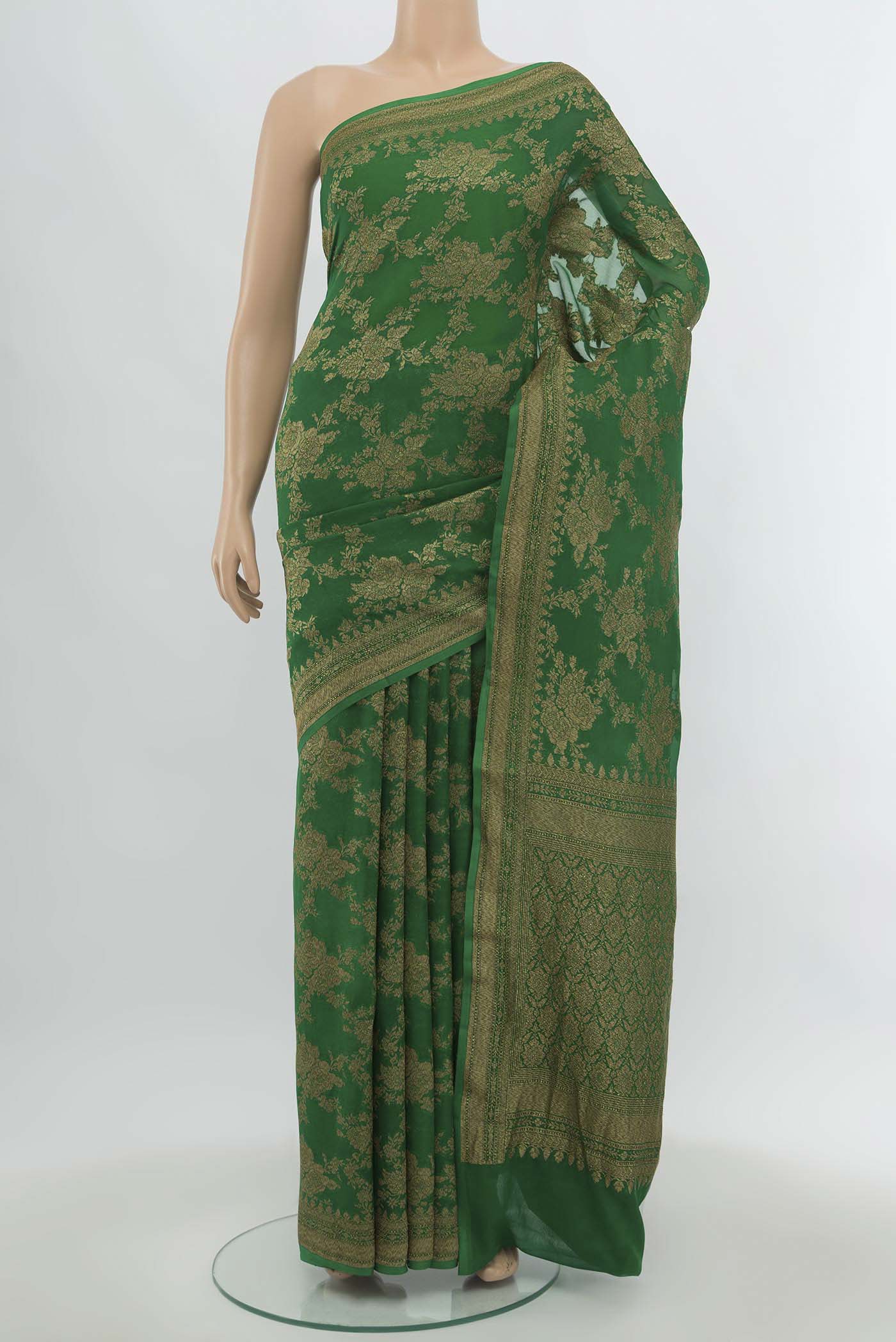 Green Banarasi Georgette Saree with Zari Butta on the body and Silk Border.  displayed on a mannequin