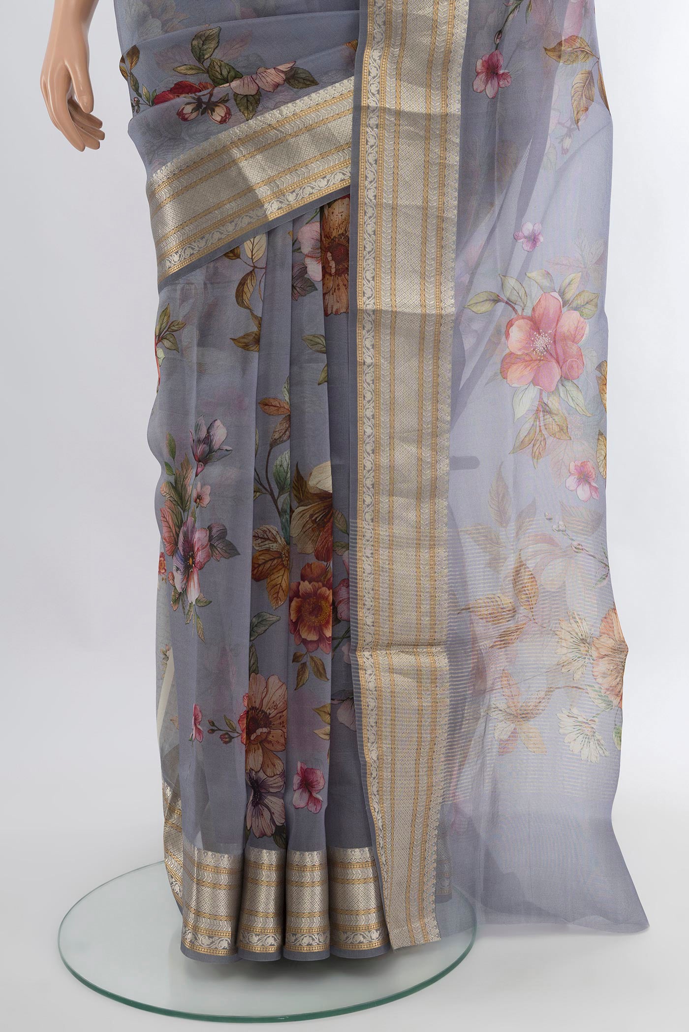 Pleats and pallu of Davys Grey Organza Silk Saree with Floral Print on the body and Zari Border. 