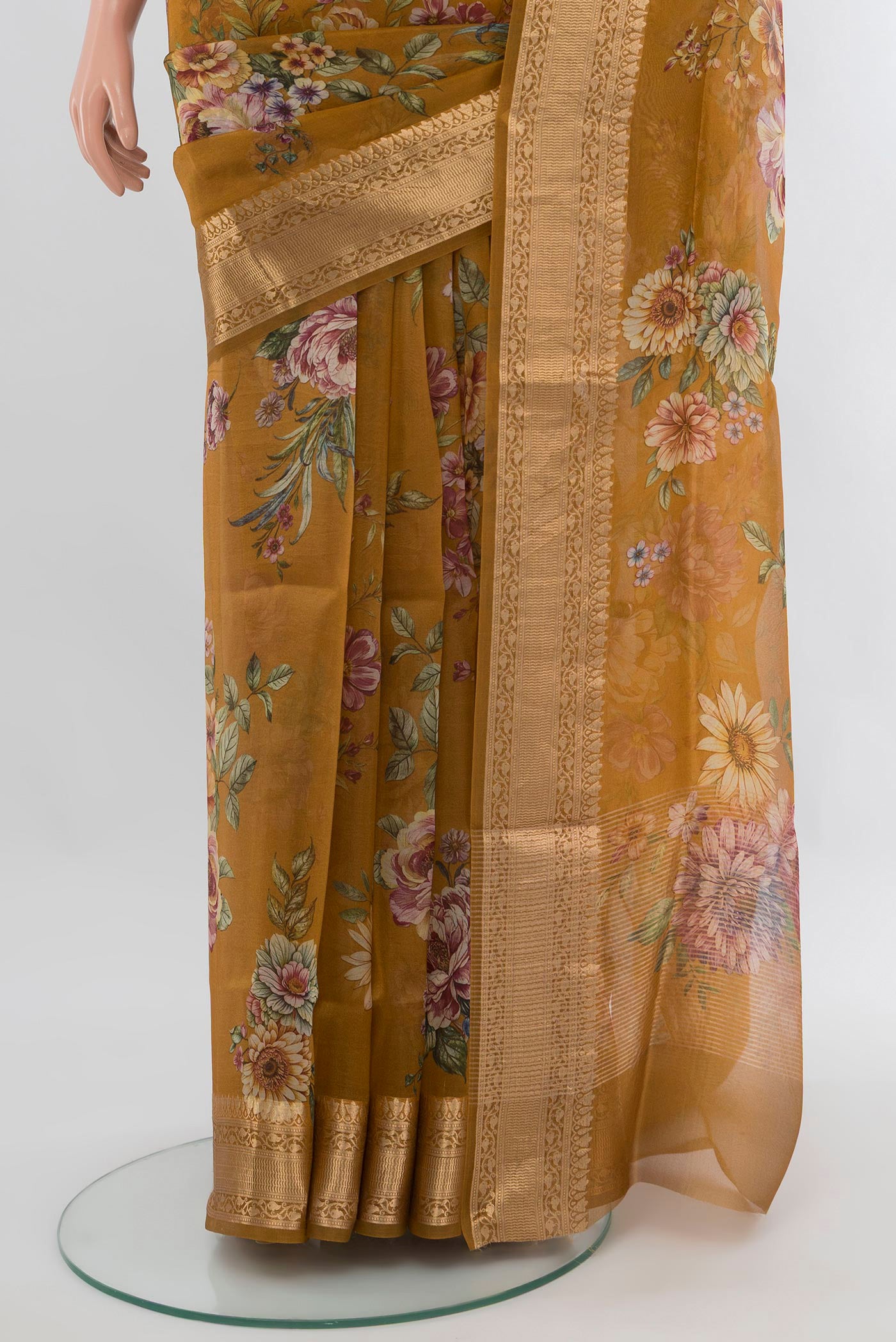 Pleats and pallu of Mustard Organza Silk Saree with Floral Print on the body and Zari Border. 