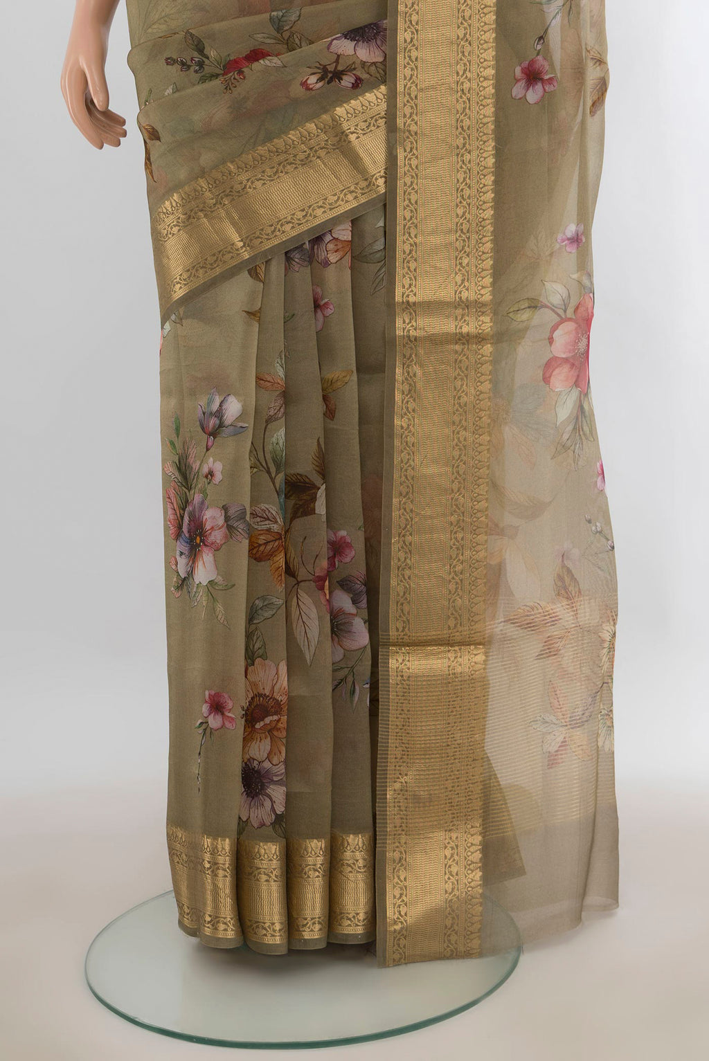 Pleats and pallu of Green Organza Saree with Floral Print on the body and Zari Border. 