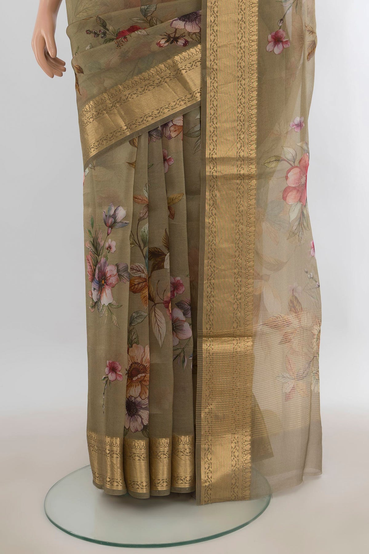 Pleats and pallu of Green Organza Saree with Floral Print on the body and Zari Border. 