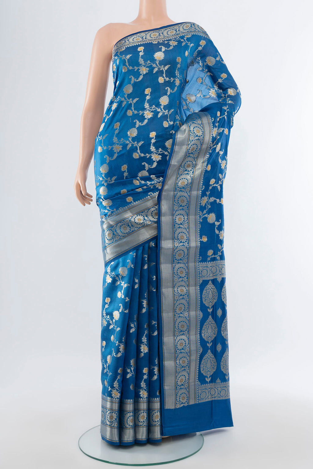 Electric Blue Banarasi Raw Silk Saree with Zari Butta on the body and Zari Border.  displayed on a mannequin