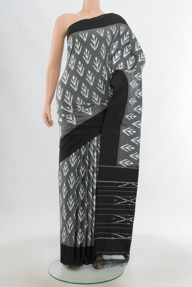 Black Pochampally Saree with Zari Butta on the body and Silk Border.  displayed on a mannequin