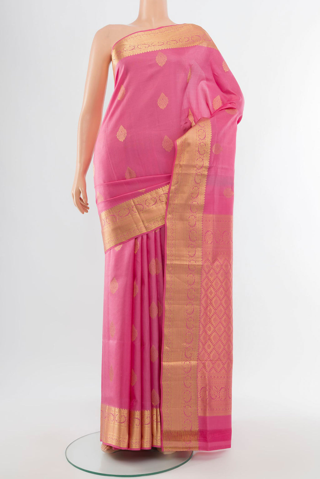 Rose Gold Soft Silk Saree with Zari Butta on the body and Silk Border.  displayed on a mannequin