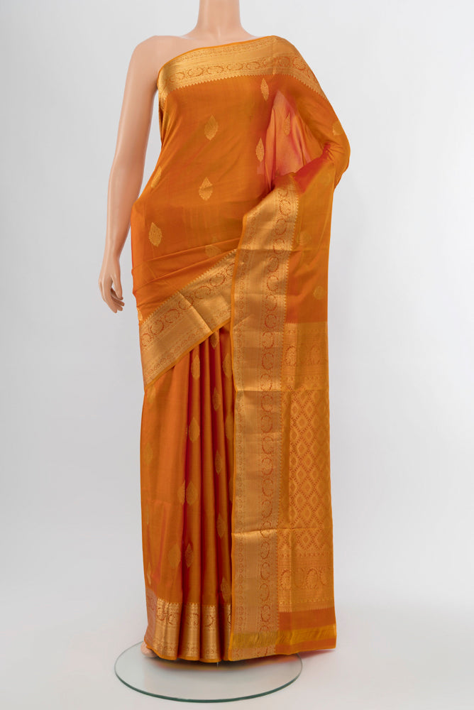 Mustard Soft Silk Saree with Zari Butta on the body and Silk Border.  displayed on a mannequin