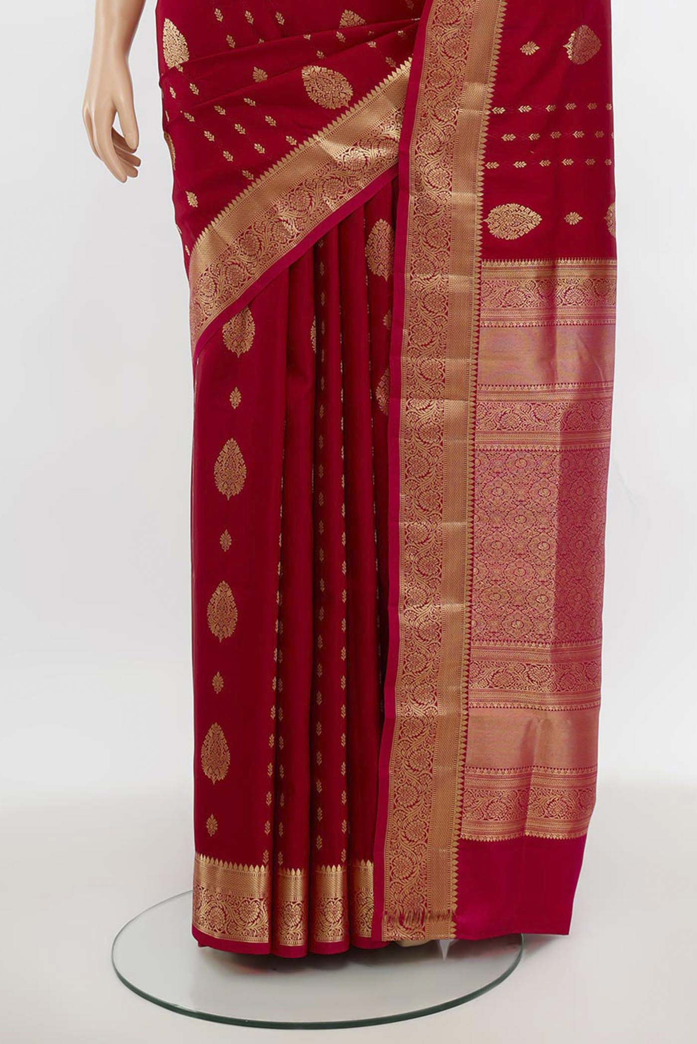 Pleats and pallu of Maroon Soft Silk Saree with Zari Butta on the body and Silk Border. 