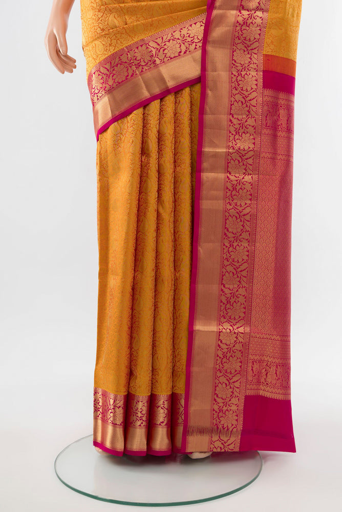 Pleats and pallu of Golden Kanchipuram Silk Saree with Zari Butta on the body and Silk Border. 