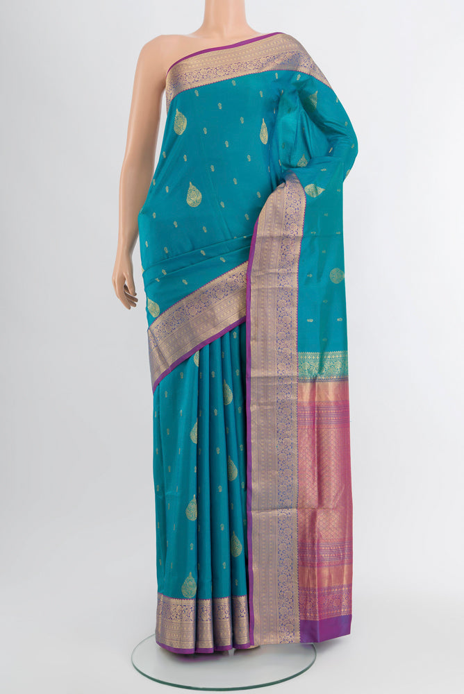 Light Blue Soft Silk Saree with Zari Butta on the body and Silk Border.  displayed on a mannequin