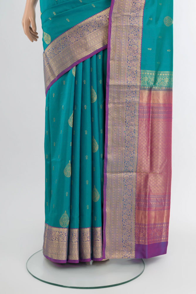 Pleats and pallu of Light Blue Soft Silk Saree with Zari Butta on the body and Silk Border. 