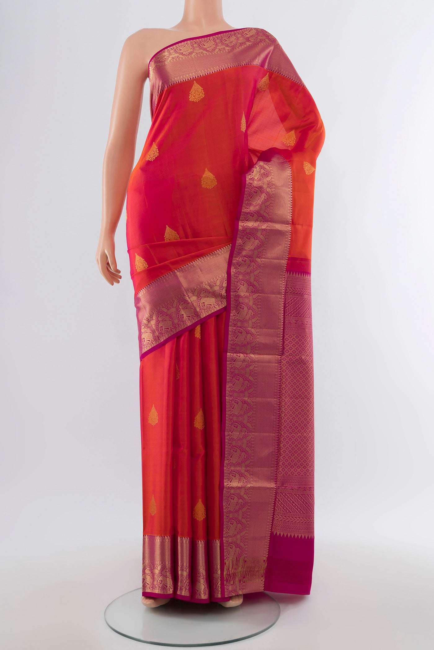 Golden Peach Soft Silk Saree with Zari Butta on the body and Silk Border.  displayed on a mannequin