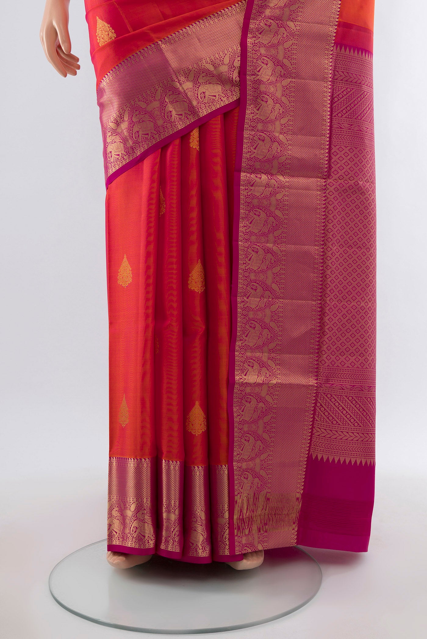 Pleats and pallu of Golden Peach Soft Silk Saree with Zari Butta on the body and Silk Border. 
