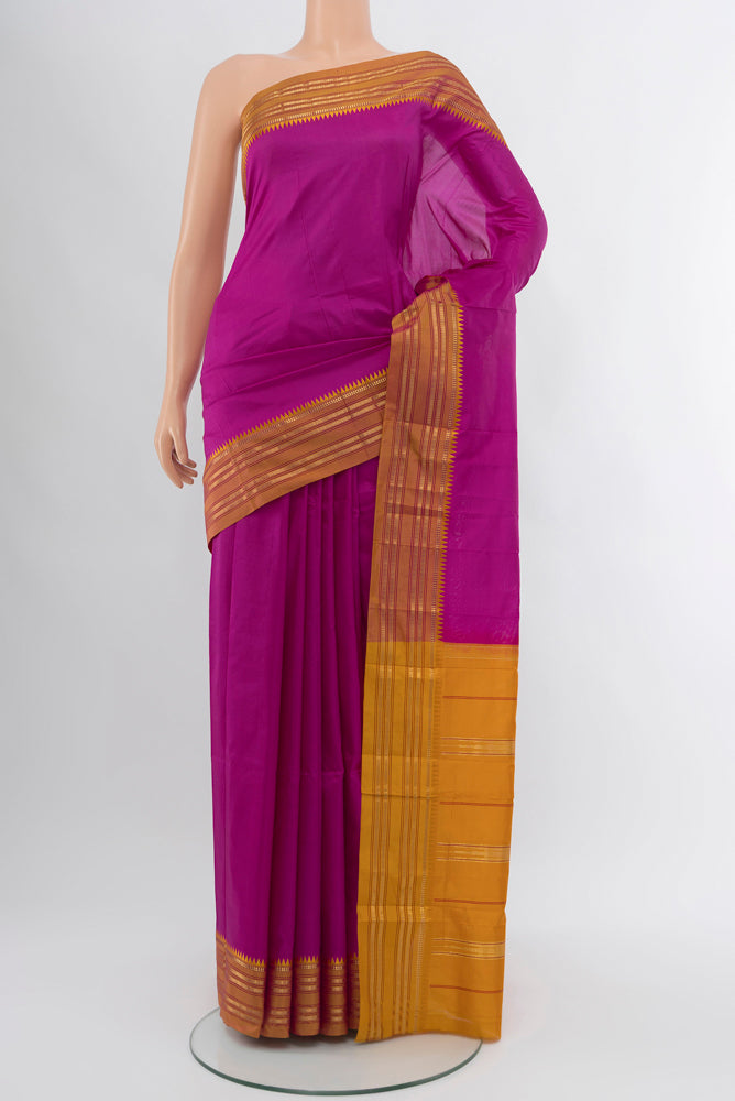 Magenta Narayanpet Silk Saree with Zari Butta on the body and Silk Border.  displayed on a mannequin