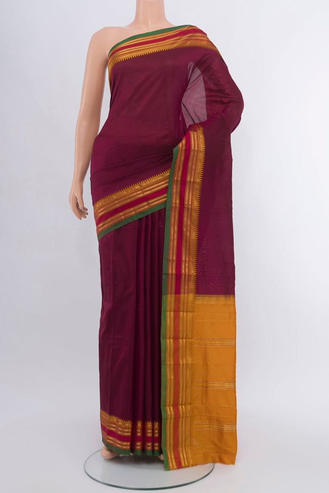 Coffee Brown Rajkot Patola Silk Saree with Zari Butta on the body and Silk Border.  displayed on a mannequin
