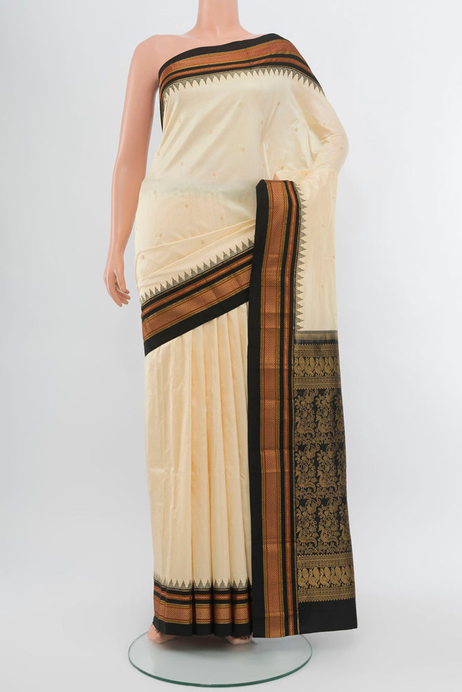 Cream Narayanpet Silk Saree with Zari Butta on the body and Silk Border.  displayed on a mannequin